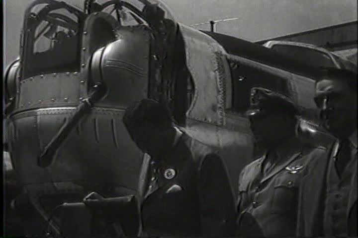 1940s - Henry Ford and other works at the plant sign planes rolling off the assembly line during World War Two.