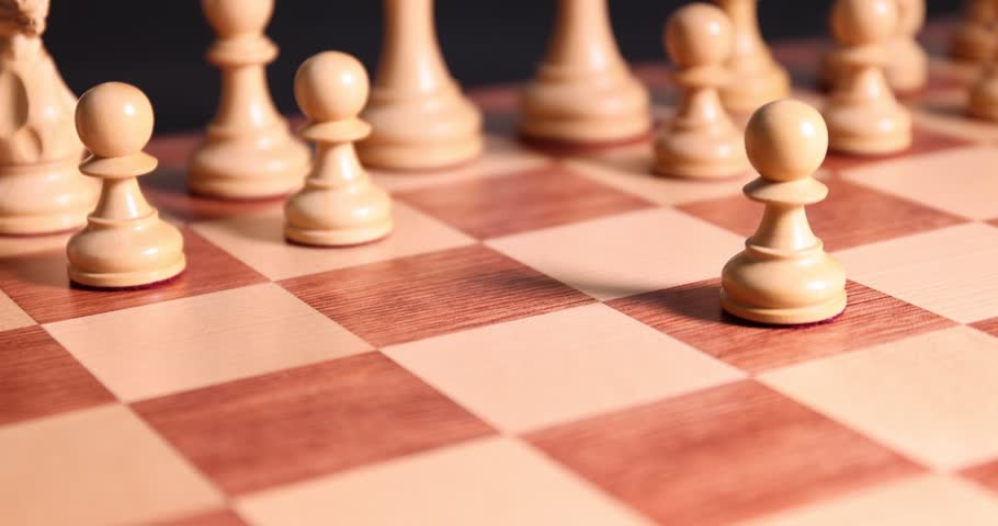 Woman moving pawn on chessboard, closeup view