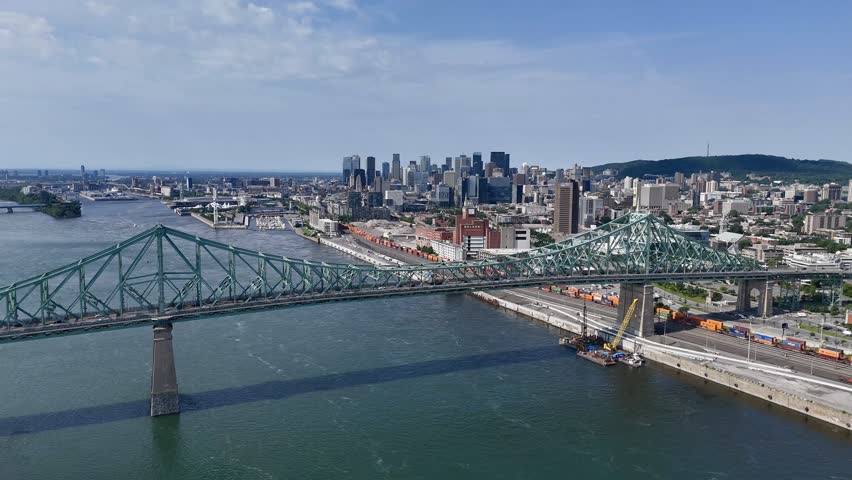 Aerial view of Montreal skyline, Jacques Cartier Bridge and La Ronde amusement island on St Lawrence River. g.