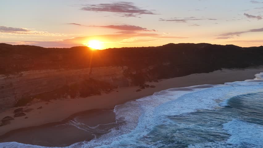 Gibson Steps and Port Campbell National Park, Great Ocean Road, Victoria, Australia: 4K aerial drone footage of cliffs, beach, ocean waves and coastal landscape near Twelve Apostles at sunrise. 