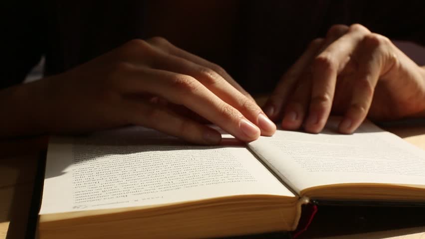 Close-up: Female hand thumb through the book (HD)