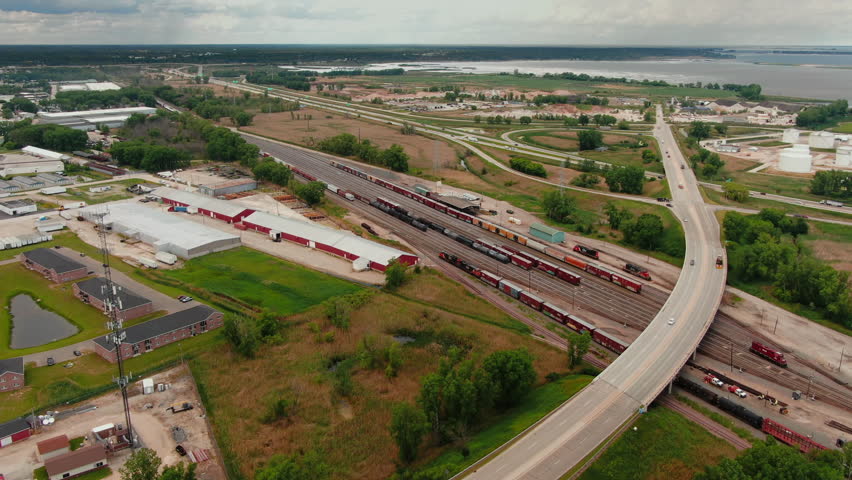 Aerial Forward Shot Across Highway Bridge with Cars Towards Rail Yard in Green Bay, Wisconsin