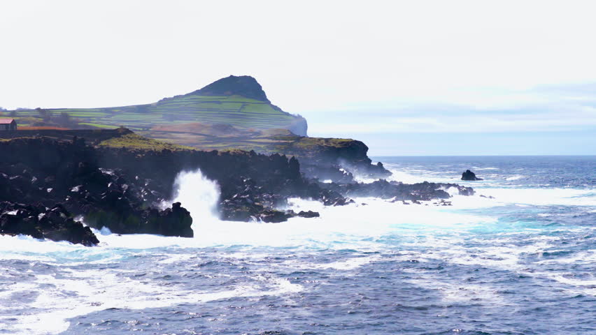 Rugged Volcanic Cliffs And Crashing Waves on Terceira Island In Azores, Portugal. - aerial shot