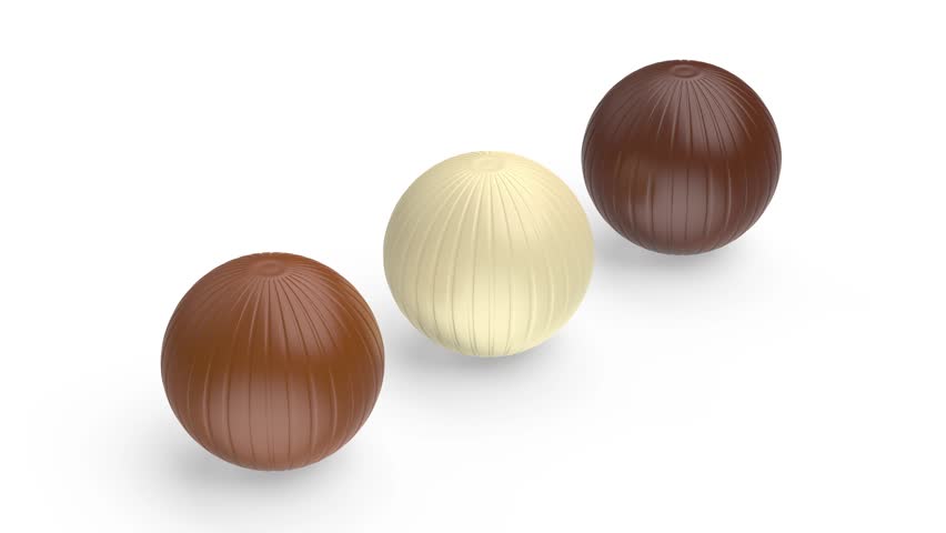 White, milk and dark chocolate balls on white background