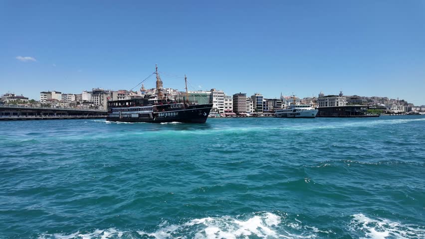 Traditional Passenger Ferry Cruising the Turquoise Bosphorus Strait with Galata Tower Skyline in Istanbul