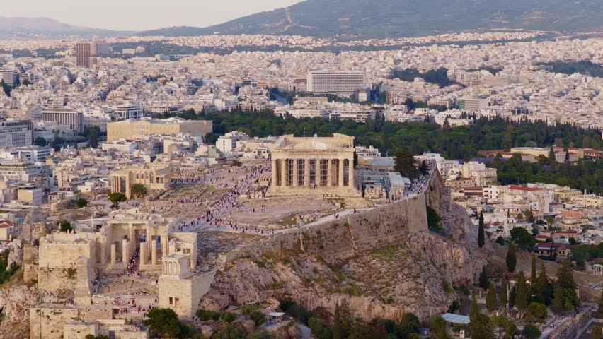 Aerial view of the acropolis of athens, greece, with the parthenon temple and the surrounding city. Majestic ancient greek monument illuminated by the warm light of the setting sun