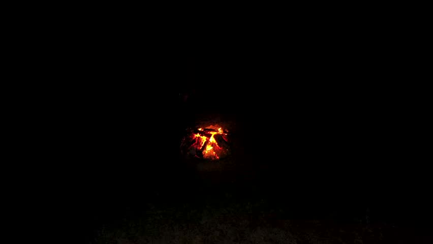 Aerial view of campfire in mountains father with daughter warming near fireplace