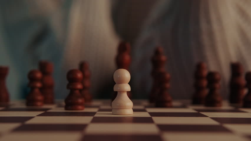 A close-up view captures a hand making a strategic move on a chessboard. A dark pawn captures a white pawn, showcasing the competitive and intellectual nature of this classic board game. Ideal for themes of strategy and competition.