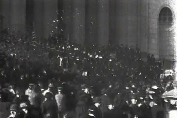1910s - Huge crowds attend a military parade and rally during World War One.