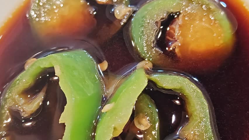 Fresh green chili rings preserved in a savory soy-based sauce with garlic, a classic Cantonese condiment often served with white-cut chicken or rice rolls.