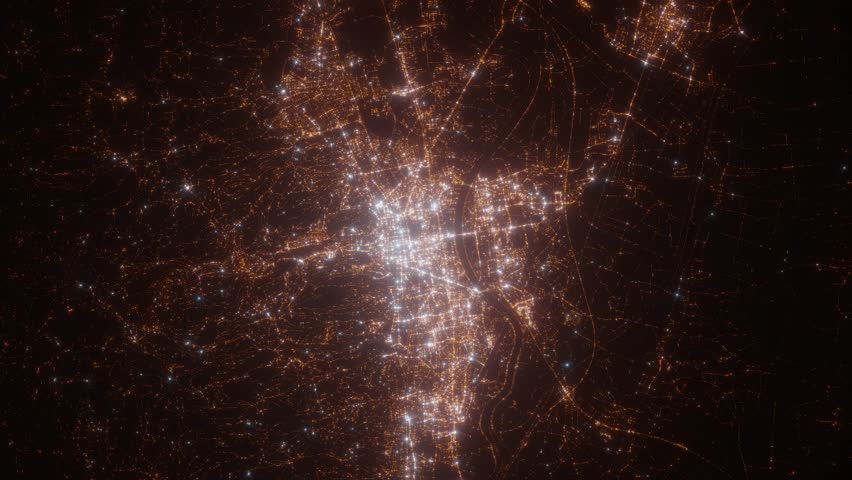 Zagreb (Croatia) aerial view at night. Top view on modern city with street lights. Camera is zooming out, rotating counterclockwise. Vertical video. The north is on the left side
