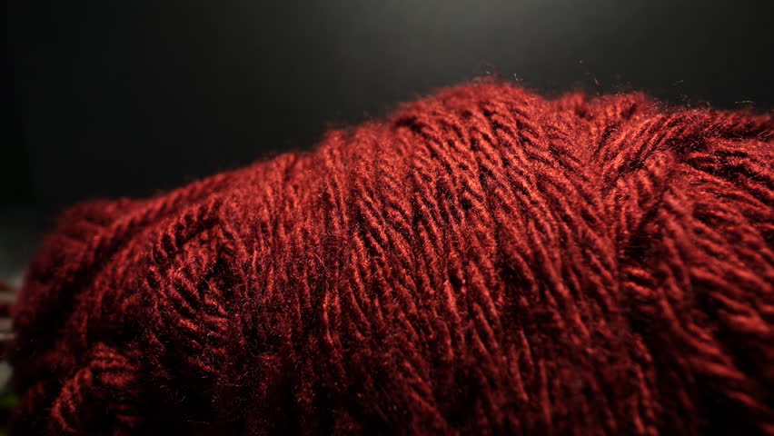 50p slider extreme close up shot of red wool yarn texture with shallow depth of field, highlighting fibers, textile details and soft material