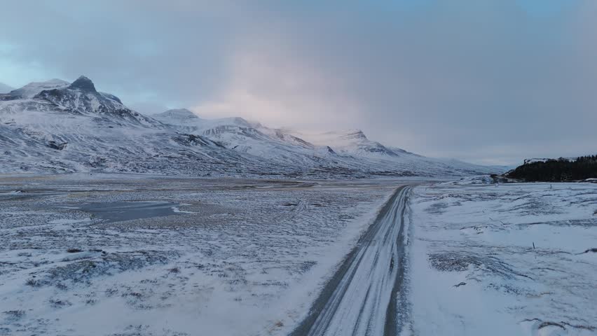 Vast winter landscape with snowy road in Iceland mountains