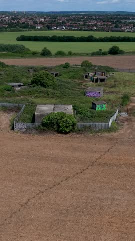 WWII gun emplacements at Chadwell Heath filmed in a forward vertical drone flyover over Whalebone Lane anti-aircraft battery ZE1, concrete bunkers and surrounding Essex fields.