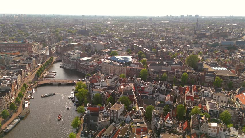 Amsterdam Orbiting Drone View Over Historic Center Showcasing Winding Canals and Facades