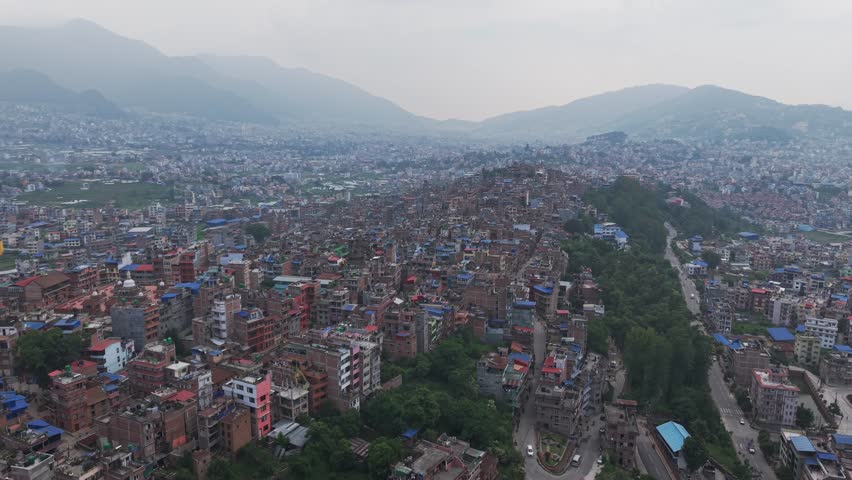 Aerial view of Kirtipur, Nepal, featuring traditional houses, temples, and the historic landscape of the Kathmandu Valley.