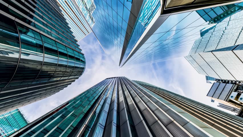 Low angle time lapse view of looking up directly at the skyline of the financial district in central London, modern architecture as a background