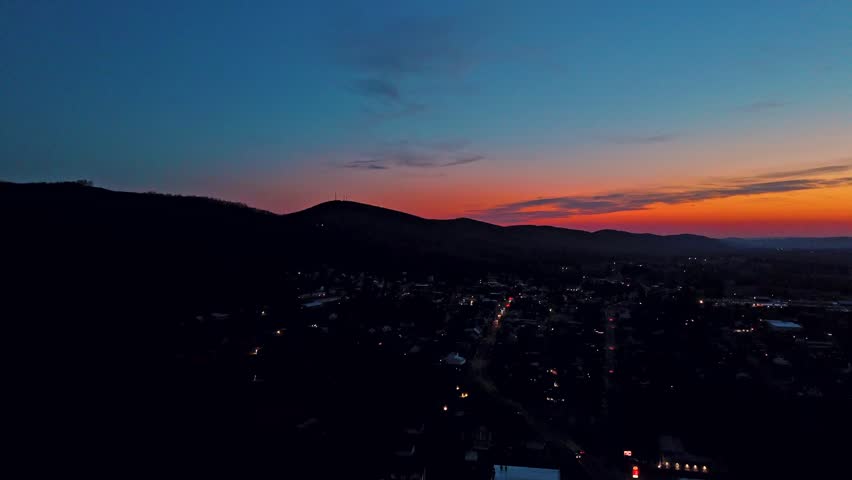 Aerial view of mountain ridge and town lights near Dalmatia Pennsylvania at sunset