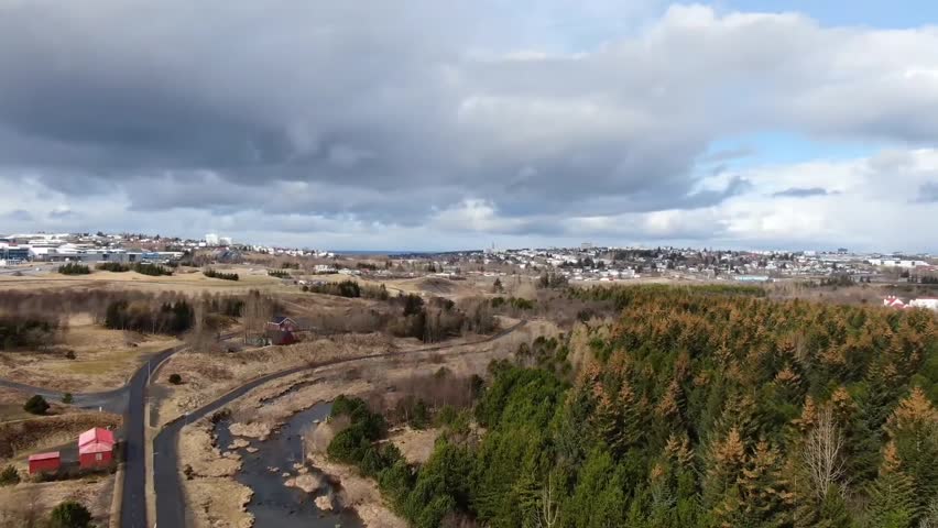 aerial Drone View of Reykjavik City Suburbs and Park Landscape in Iceland with Overcast Sky