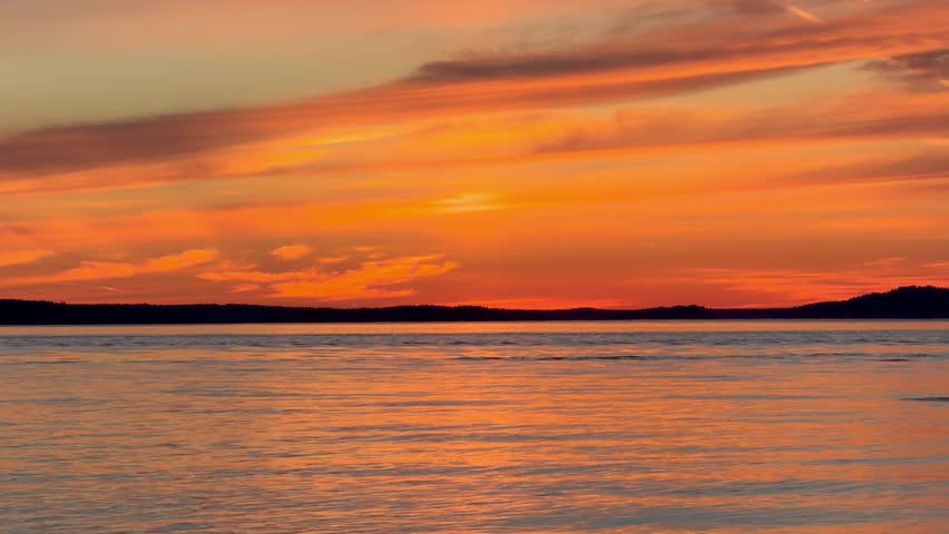 Beautiful orange sunset over the Pacific Ocean at Deception Pass state park in Washington state