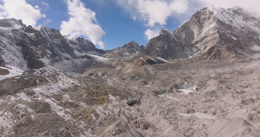 Lobuche to Gorakshep, Everest Region Nepal, aerial drone shot of the rocky and icy Khumbu Glacier alongside the Everest Base Camp trekking route beneath towering Himalayan peaks.