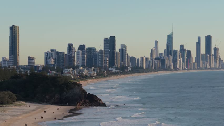 Forward aerial view panning to the right toward the Surfers Paradise skyline from North Burleigh on the Gold Coast, Queensland, Australia