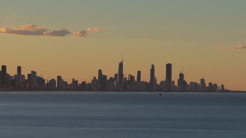 Surfers Paradise And Broadbeach Suburbs During Sunrise In Gold Coast, QLD, Australia. - aerial shot