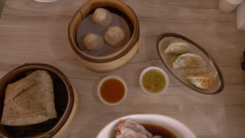 Assorted Dim Sum Dishes Served With Dipping Sauces On A Table At Tuang Dim Sum Restaurant In Bangkok, Thailand