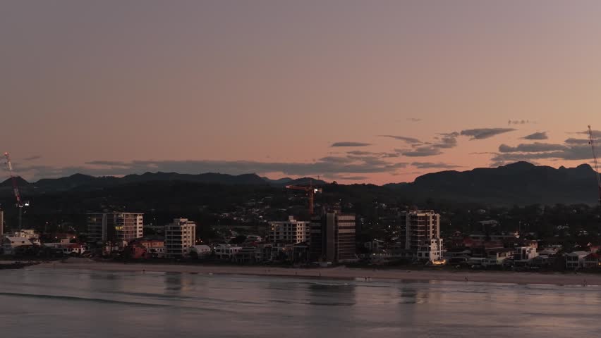 Palm Beach With Beachfront Buildings At Twilight In Gold Coast, Queensland, Australia - Drone Shot