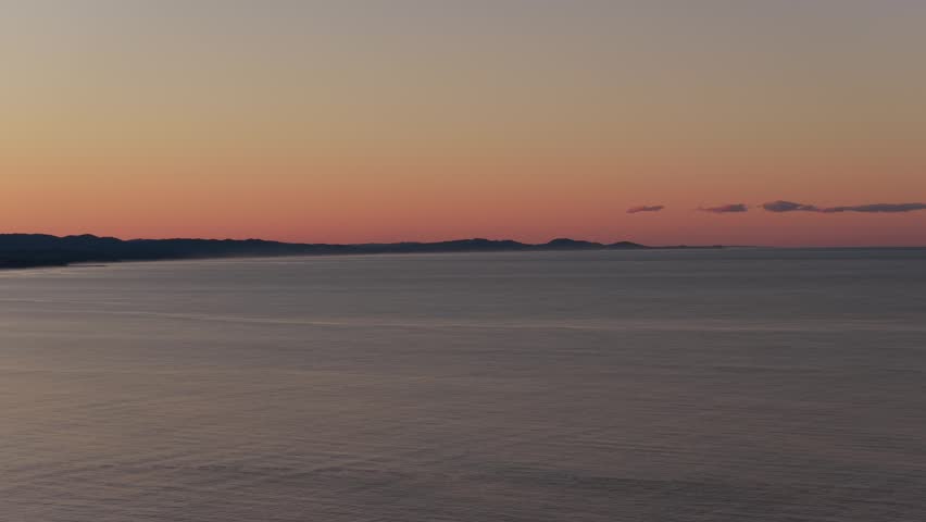 Sunset Over The Calm Ocean - Walgun Cape Byron In NSW, Australia. - aerial wide shot