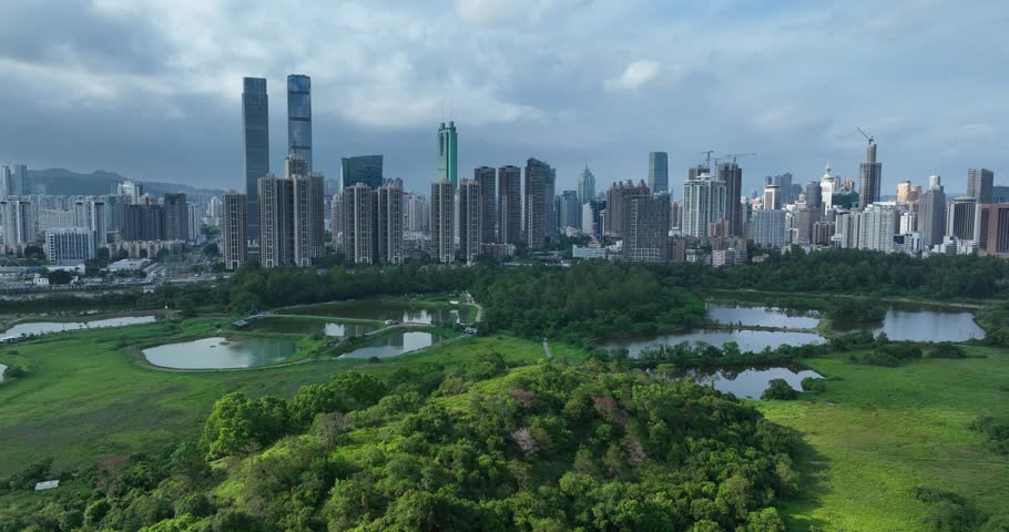 Rural green fields with fish ponds between Hong Kong and skylines of Shenzhen, China	