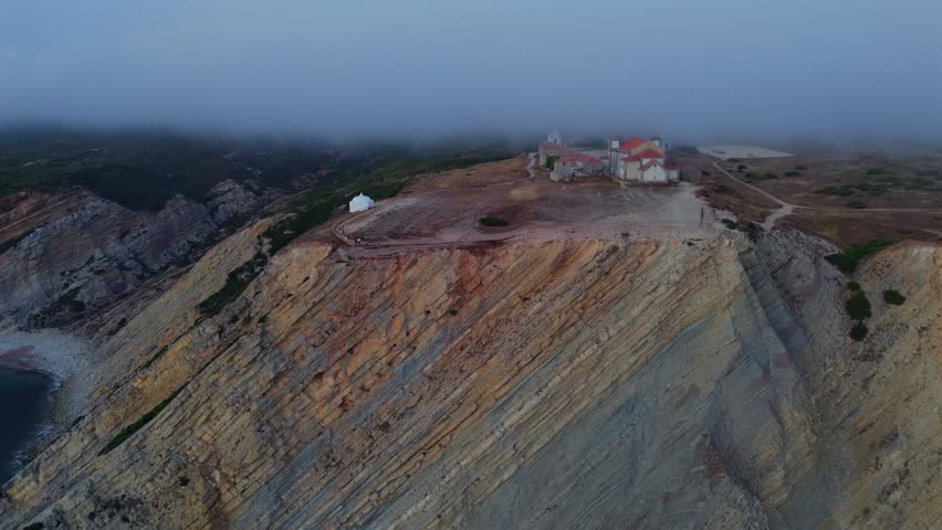 Close Aerial View of Warm Colored Rocky Coastal Cliff Surfaces With Mineral Texture