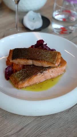 Pan-Seared Salmon Fillet With Crispy Skin Served With A Butter Sauce In The Restaurant. - closeup, vertical shot