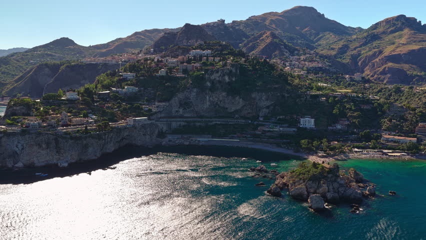 Aerial Slow Pan of Taormina Isola Bella Bay Italy Sicily and Mountain Coastline Landscape
