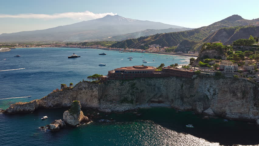 Aerial Drone Dolly In Italy Sicily Taormina Cliff Coastline Waterfront Road and Mount Etna