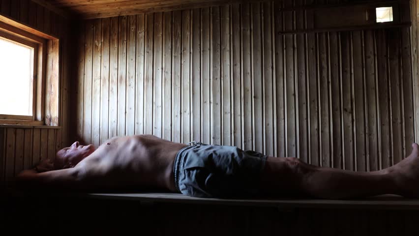 Stockholm, Sweden A man does exercises in a warm wooden sauna. 