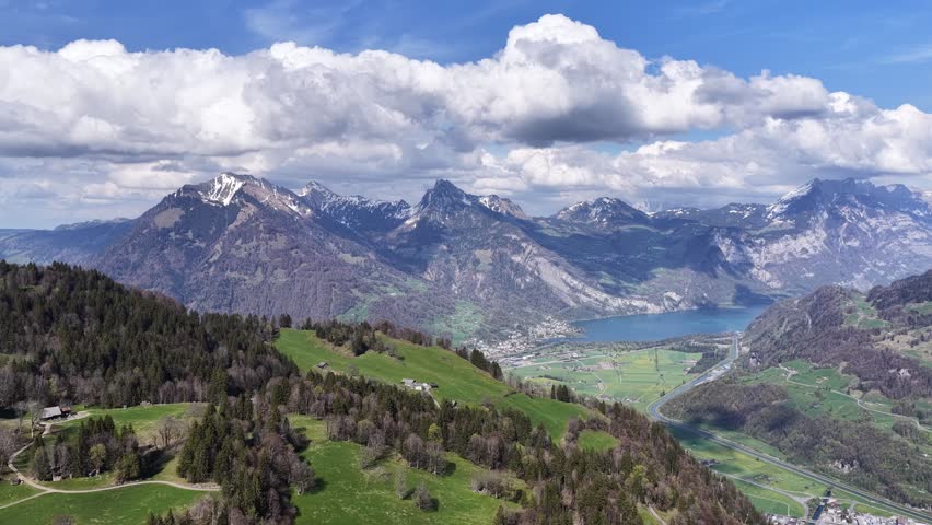Panoramic landscape overlooking Obersee near Näfels in Glarus, Switzerland, with alpine meadows, dramatic mountain peaks, and the turquoise lake below.