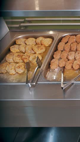 buffet restaurant. self-service cafeteria. close-up. display showcase with freshly cooked hot meals. health food.