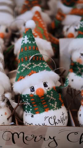 Christmas shopping, decorations, Fair. festive accessories. close-up. Christmas decorations in the shape of funny snowmen. Merry Christmas and Happy New Year. shopping mall.