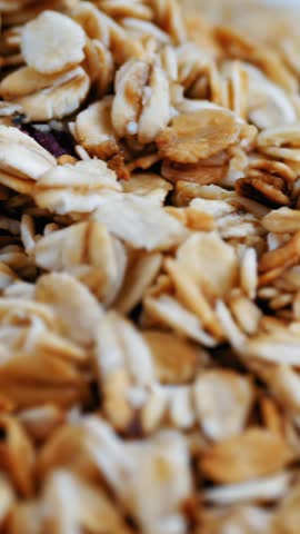 Granola. Oat flakes. close-up. rotation of a pile of dry oat flakes, grains with berries and nuts. Food background. Macro rotation. healthy, organic food. Gastronomy. rotation food