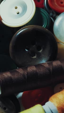 Sewing buttons. close-up. rotation. Various round colored sewing buttons rotate on turntable. Loop motion background. concept of color, fashion, dressmaking, sewing, tailor.