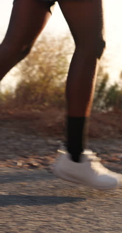 Fitness, legs and running with person outdoor for action, cardio training or wellness. Challenge, exercise and pace with runner on path in nature for development, improvement or workout routine
