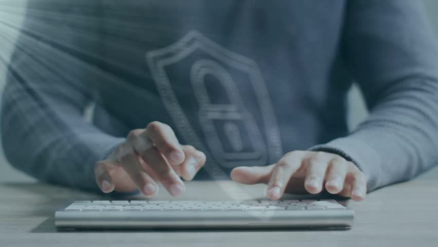 Adult male typing keyboard at desk appearing dotted shield lock centred over keys showing security. Hand, workspace, privacy, encryption, cybersecurity, holographic, minimalist