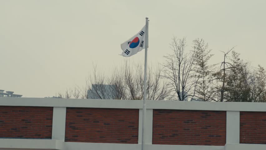 The South Korean National Flag Waving above a Modern Brick Wall at the National Folk Museum of Korea in Seoul