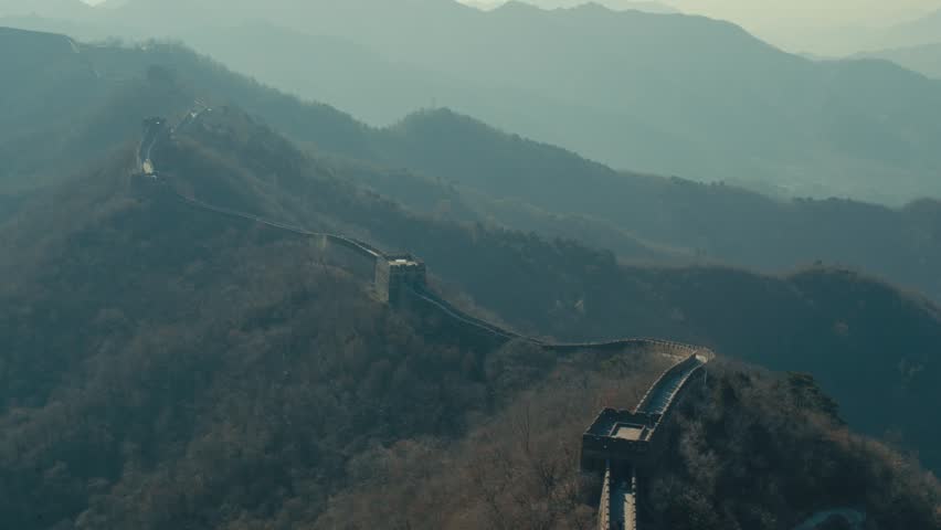 Beijing Ancient Great Wall fortification winding along hazy mountain peaks in China