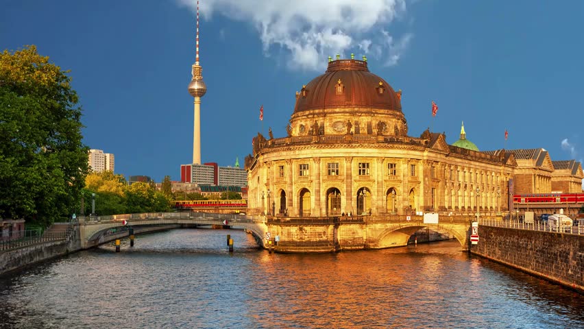 Berlin, Germany - The Bode Museum, Berlin, GermanyBerlin, Germany- Circa 2018: Hyper lapsed view of The Bode Museum in the Museum Island. Bridge over Spree river. Famous TV Tower, Fernsehturm Berlin and skyline in the background.