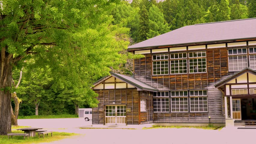 Wooden school and trees in Japanese countryside