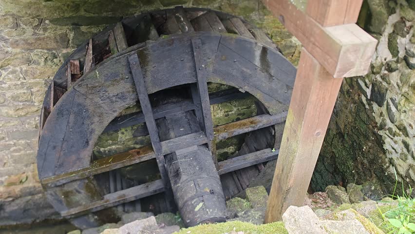 Historic wooden watermill wheel dating from the seventeenth century preserved at a traditional European mill