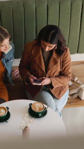 Phone, typing and above with friends in coffee shop for social media, bonding and reunion. Online restaurant rating, scroll and relax with women and tech in cafe for communication and customer review