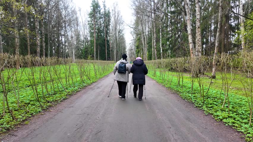 Nordic walking in the park in early spring. Slowmotion